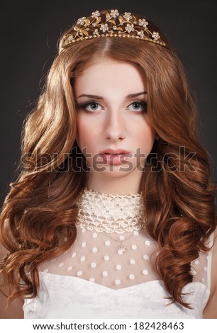 Beauty jewelry Girl Portrait, red hair woman with bright makeup and long curly hair and diamond tiara, Gorgeous Woman Portrait. Stylish Haircut. Hairstyle. Make up. Vogue Style. Sexy Glamour Girl