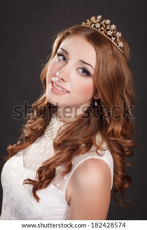 Beauty jewelry Girl Portrait, red hair woman with bright makeup and long curly hair and diamond tiara, Gorgeous Woman Portrait. Stylish Haircut. Hairstyle. Make up. Vogue Style. Sexy Glamour Girl
