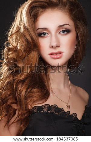 Beauty woman face with bright makeup smokey eyes, jewelry model with curly red hair. Sexy brunette woman portrait. Beautiful woman with evening make-up. Jewelry and Beauty. Fashion photo