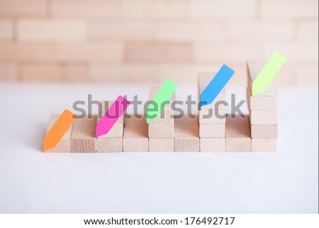 Wood graph with brown blurry background and colorful sticker