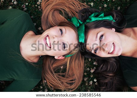 Two sisters in green on grass, st patricks day