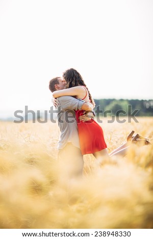 Couple in Wheat Field Woman Being Picked up and kissed