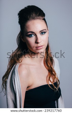 Studio Portrait of Young Attractive Woman sweater coming off right shoulder