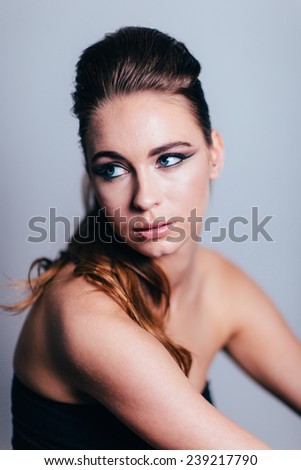 Studio Portrait of Young Attractive Woman looking away from camera to the left