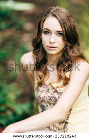 Portrait of Young Attractive Woman with beautiful blue eyes looking at camera with skull t-shirt arm crossed over body