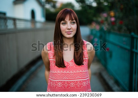 portrait of beautiful young female staring off camera on pathway