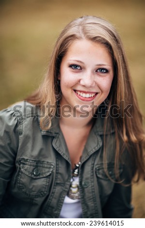 Attractive Young Blond Woman in green jacket close up