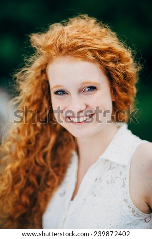 Attractive Young Female Redhead, slight smile, vertical close up