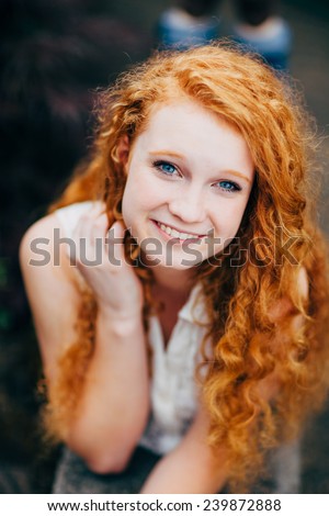 Attractive Young Female Redhead holding hair, slight smile, variation