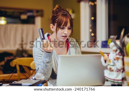 Young Woman at Computer stressed with a credit card