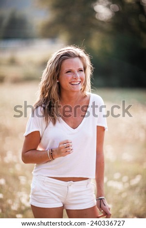 Beautiful Blonde Young Woman laughing away from camera