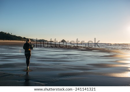 Female Runner on the Beach at Sunset behind shot more copy space