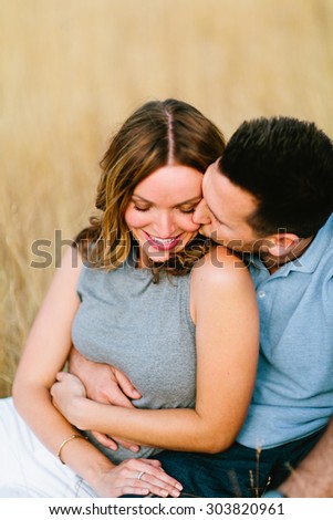 Beautiful Couple in Wheat Field Guy Kissing Cheek