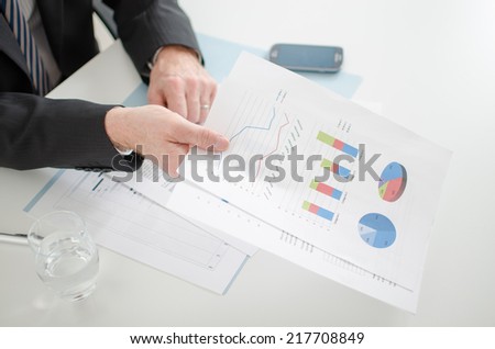 Businessman showing economic documents at the office