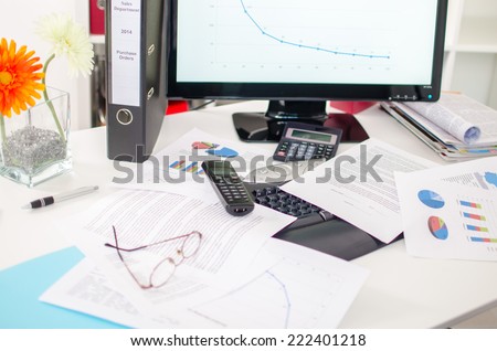 Desk cluttered with business documents