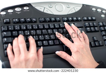 Woman\'s hands typing on a keyboard