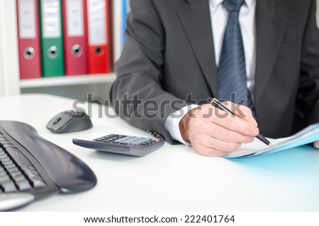 Businessman studying a document at the office