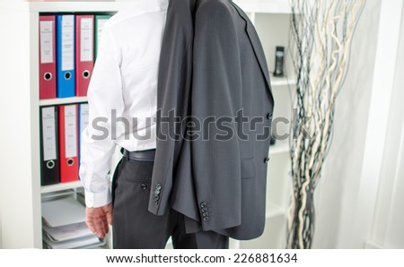 Businessman leaving the office with his jacket over his shoulder