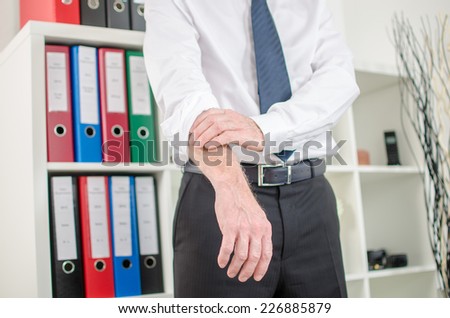 Businessman rolling up his sleeves at office