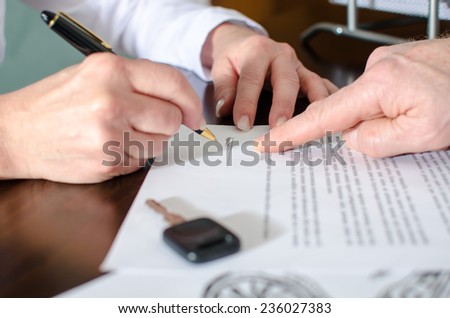 Dealer showing the signature place of a contract with his finger