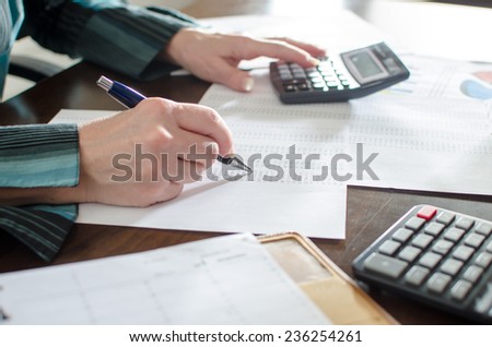 Female accountant checking financial documents at office