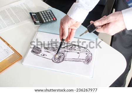 Car salesman showing a car design at the dealership office