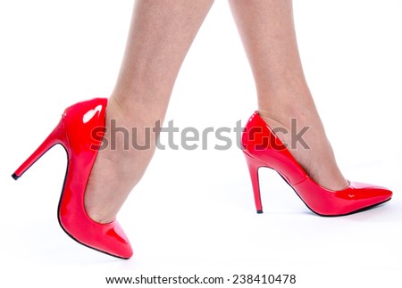 Woman wearing red high heel shoes, isolated on white
