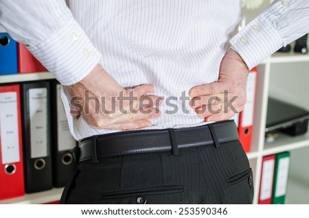 Businessman with back pain at office