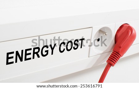 Energy cost imaged by a red plug and an electrical outlet