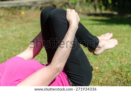 Woman doing physical exercises outdoors