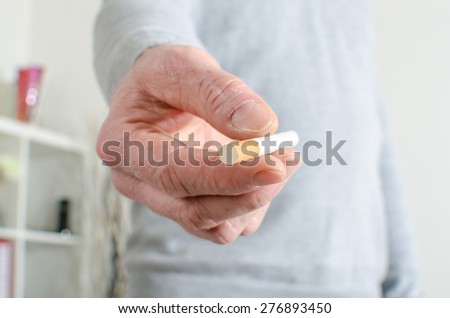 Man hand offering a cigarette, closeup