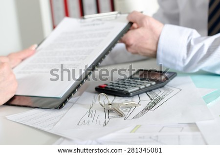 Realtor showing a real estate contract to his client