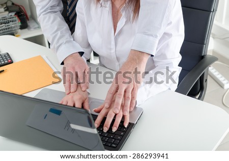 Manager putting his hands on the hands of his secretary, at office