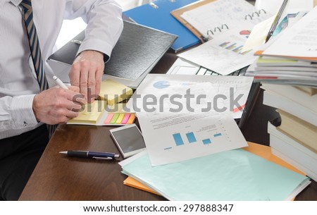 Businessman working at a untidy and cluttered desk