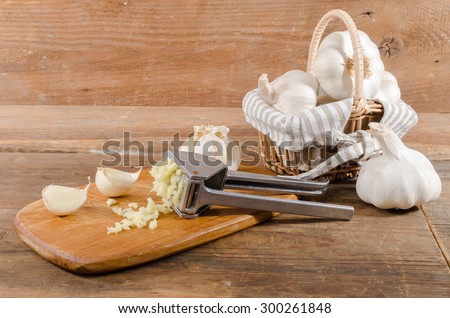 Fresh crushed garlic on wooden background
