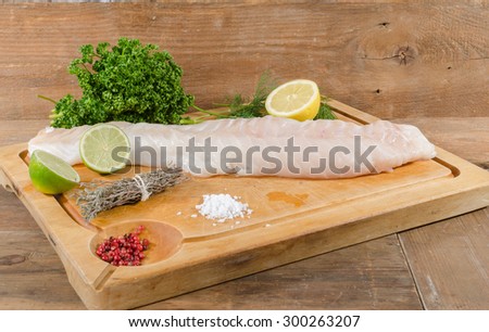 Cod fillet on wooden board