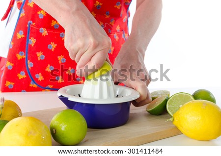 Woman squeezing half a lemon on a squeezer