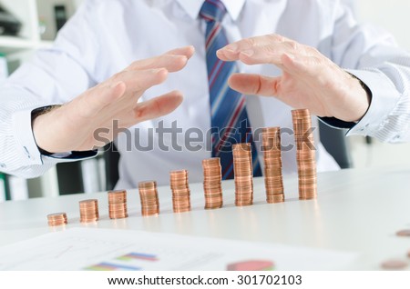 Businessman hands protecting money