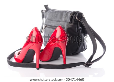 Red high heels shoes with a black handbag, isolated on white