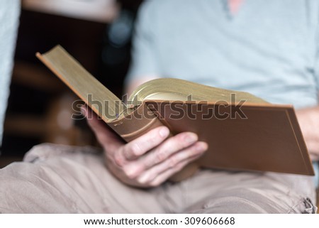 Man sitting at home reading the Bible
