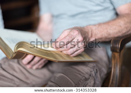 Man sitting at home reading the Bible