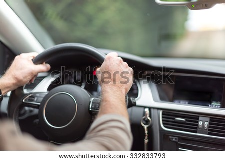 Car driving with both hands on the wheel