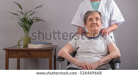 Nurse comforting an old patient