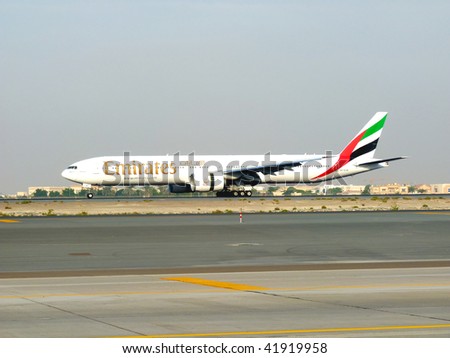 DUBAI, UAE - NOVEMBER 18: Emirates Boeing 777 aircraft landing during Dubai Air Show at Airport Expo Dubai November 18, 2009 in Dubai, United Arab Emirates.