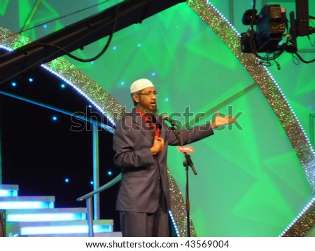 DUBAI, UAE - AUGUST 28: Dr Zakir Naik famous Muslim preacher and orator delivers speech to crowd at Airport Expo Centre August 28, 2009 in Dubai, UAE.