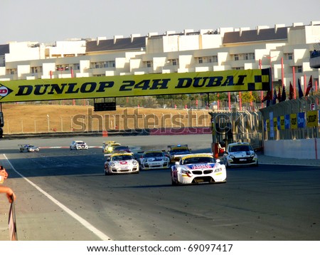 DUBAI,UNITED ARAB EMIRATES-JANUARY 14: Racing Cars Speeding their way on the start finish line at Dubai Autodrome Circuit during Dunlop 24H Dubai Race January 14, 2011 in Dubai,UAE