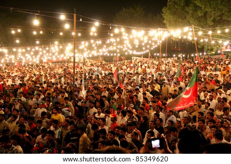 GUJRANWALA, PAKISTAN - SEPT. 25: Large crowd of people listening to Imran Khan at a political rally of Pakistan Tehreek-e-Insaf on September 25, 2011 in Gujranwala, Pakistan