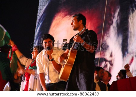 LAHORE, PAKISTAN - OCT 30: Strings music group performing patriotic songs during a political rally of Pakistan Tehreek-e-Insaf on October 30, 2011 in Lahore, Pakistan