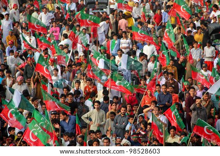 SIALKOT, PAKISTAN - MAR 23: Over hundred thousand people gather at Jinnah Cricket Stadium during a political rally of cricketer turned politician Imran Khan on March 23, 2012 in Sialkot, Pakistan