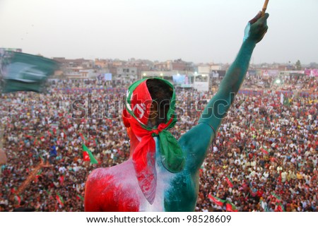 SIALKOT, PAKISTAN - MAR 23: PTI supporter at Jinnah Cricket Stadium during a political rally of cricketer turned politician Imran Khan on March 23, 2012 in Sialkot, Pakistan